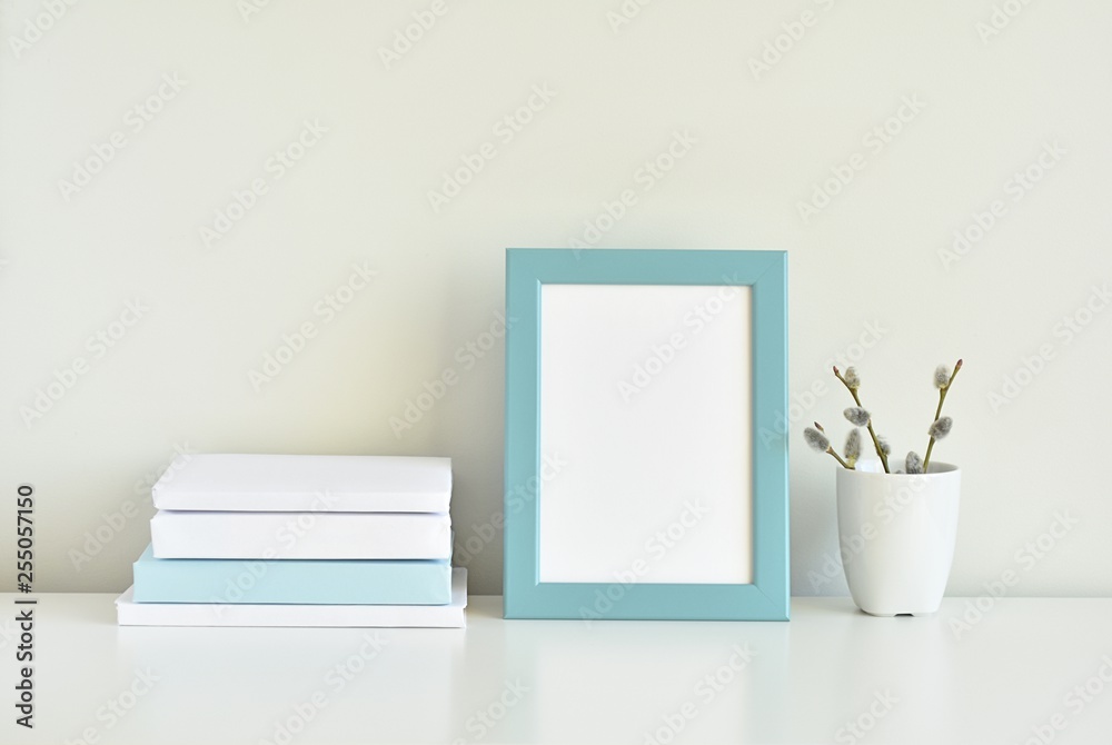 Minimal interior, blue photo frame mock up on white table, styled stock photo. Minimal interior, blue photo frame mock up on white table, styled stock photo.
