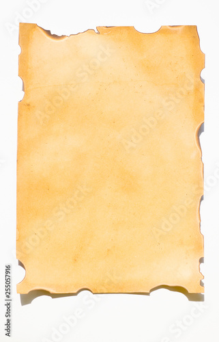 Old paper with burns and cleft marks on a white background