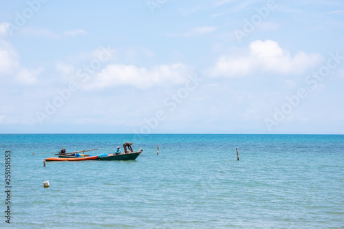 Local Fisherman Boats on the left side floating over the sea with bright sky in background in the afternoon at Koh Mak Island in Trat, Thailand.
