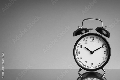 Alarm Clock on black and white background with selective focus and crop fragment. Business and Copy space concept