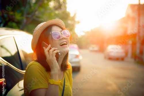 face of happiness emotion woman talking on mobile phone standing on city street side photo