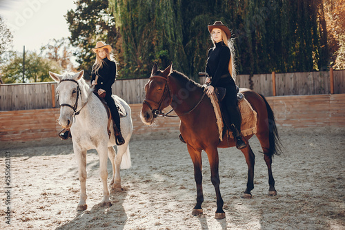 Girls with a horse. Women in a ranch. Blonde in a black sweater