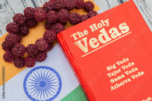 Maski,Karnataka,India - March 13,2019 :The Holy Vedas on wooden textured background with Indian flag. photo