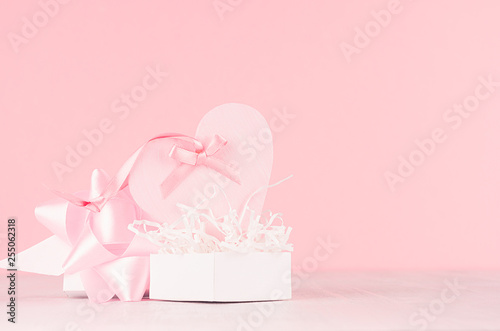 Modern fashion Valentine days background - trendy pink heart with ribbon and present on white wood board, copy space.