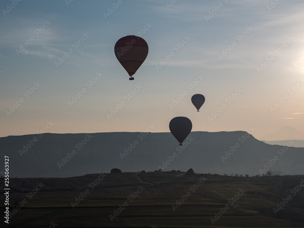 Beautiful Hot Air Balloon Flight South Cappadocia Tour Goreme Open Air Museum, Flying hot air balloons rise in sunrise Cappadocia. Goreme National Park Turkey. March, 2019 Beautiful Hot Air Balloon Flight South Cappadocia Tour Goreme Open Air Museum, Flying hot air balloons rise in sunrise Cappadocia. Goreme National Park Turkey. March, 2019
