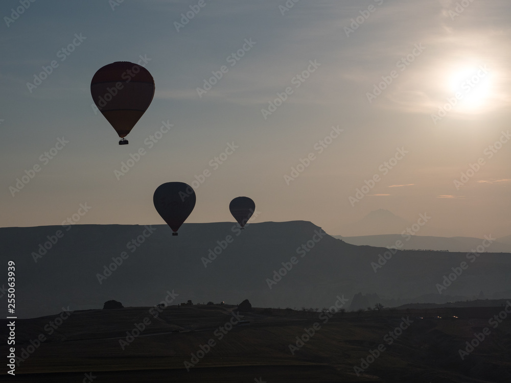 Beautiful Hot Air Balloon Flight South Cappadocia Tour Goreme Open Air Museum, Flying hot air balloons rise in sunrise Cappadocia. Goreme National Park Turkey. March, 2019 Beautiful Hot Air Balloon Flight South Cappadocia Tour Goreme Open Air Museum, Flying hot air balloons rise in sunrise Cappadocia. Goreme National Park Turkey. March, 2019