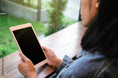 happy asian woman using tablet in cafe © amfroey01