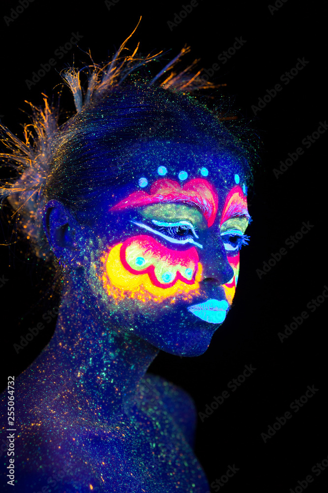 Blue woman portrait, aliens sleeps, ultraviolet make-up. Beautiful on a dark background. Semi profileportrait