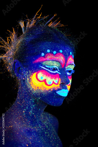 Blue woman portrait  aliens sleeps  ultraviolet make-up. Beautiful on a dark background. Semi profileportrait