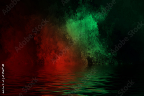 Gradient duo tone smoke with reflection in water. Red and Green fog texture. Design element texture.