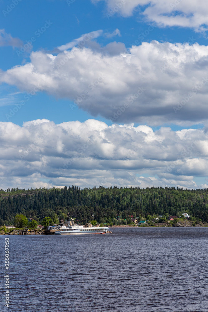 View of the bay shore in Ladoga Lake under a blue sky with clouds near Sortavala, Karelia. Russia