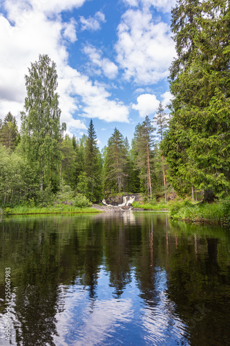 Ruskeala Waterfalls in the forest under a blue sky with clouds  Karelia. Russia