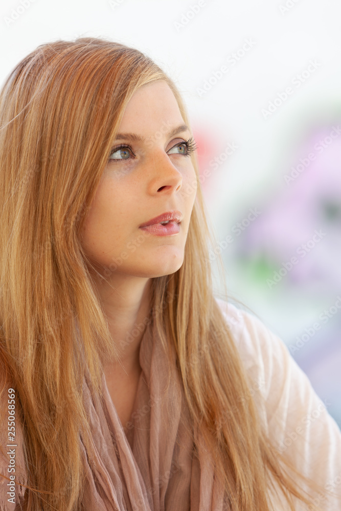 Fototapeta premium Pensive woman daydreaming and looking away absorbed in her thoughts.