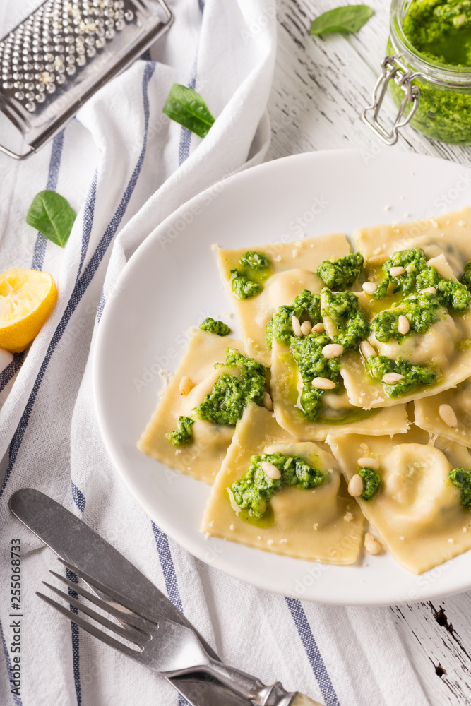 Italian spinach ravioli with pesto sauce and parmesan. Italian spinach ravioli with pesto sauce and parmesan.
