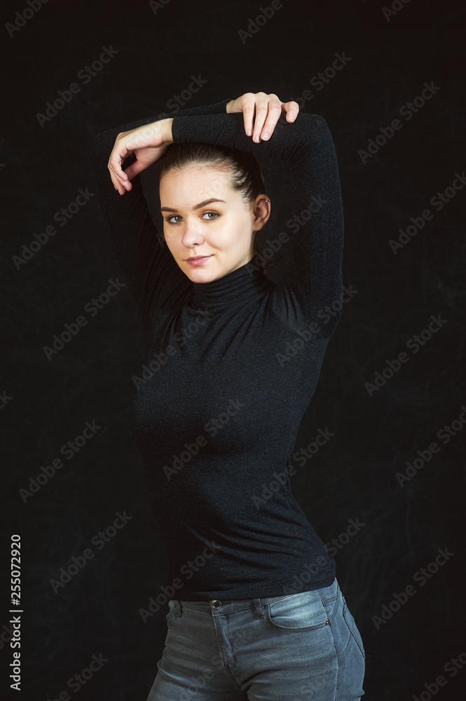 Studio portrait of a young beautiful woman on a dark background Studio portrait of a young beautiful woman on a dark background