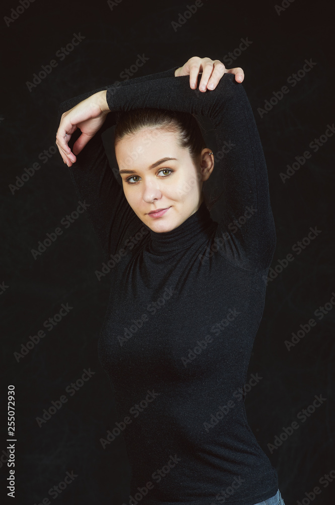 Studio portrait of a young beautiful woman on a dark background