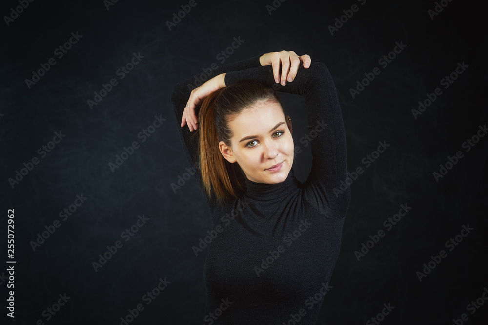 Studio portrait of a young beautiful woman on a dark background