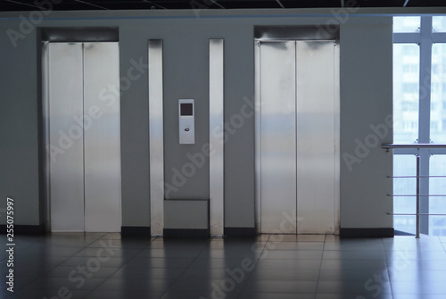 closed Elevator doors and control panel in a modern office building
