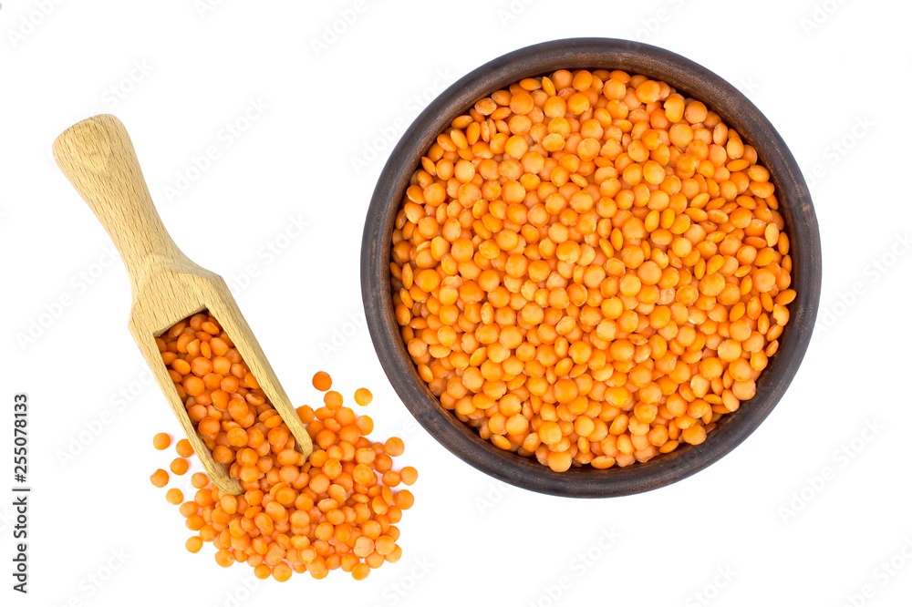 Red lentils in plate and scoop isolated on white background Red lentils in plate and scoop isolated on white background