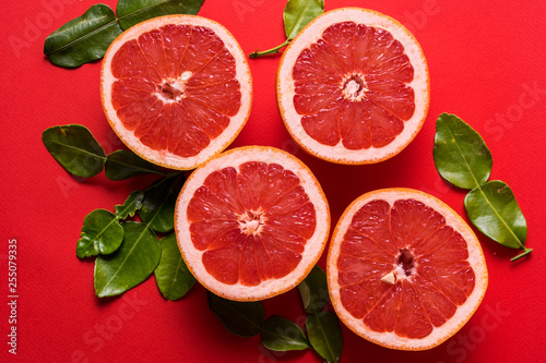Flat lay the pattern with raw fresh red orange citrus fruit with green leaves.