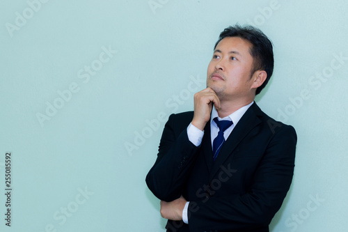 A studio image of an Asian businessman with a handsome beard and a background