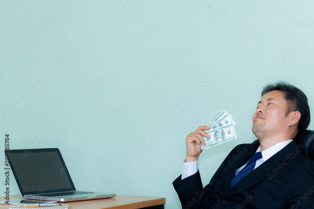 A studio image Male businessmen are happy about the money they find. mint green background A studio image Male businessmen are happy about the money they find. mint green background