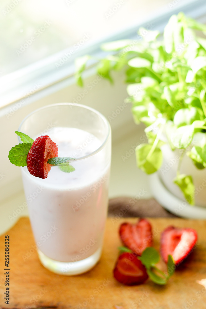Strawberry smoothie or milkshake in jar on white rustic background, healthy food for breakfast and snack Strawberry smoothie or milkshake in jar on white rustic background, healthy food for breakfast and snack