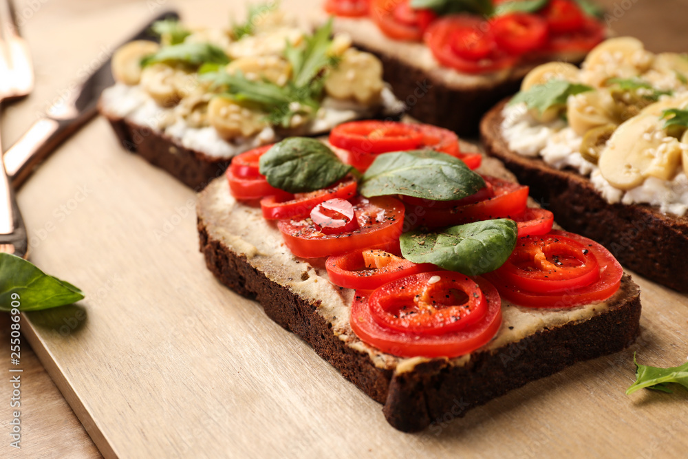 Fresh tasty bruschettas on wooden board, closeup Fresh tasty bruschettas on wooden board, closeup