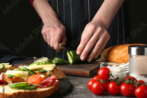 Fototapeta Naklejka Na Ścianę i Meble -  Woman preparing tasty bruschettas