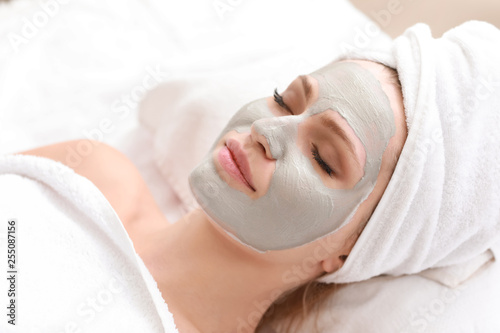 Young woman with facial mask in beauty salon