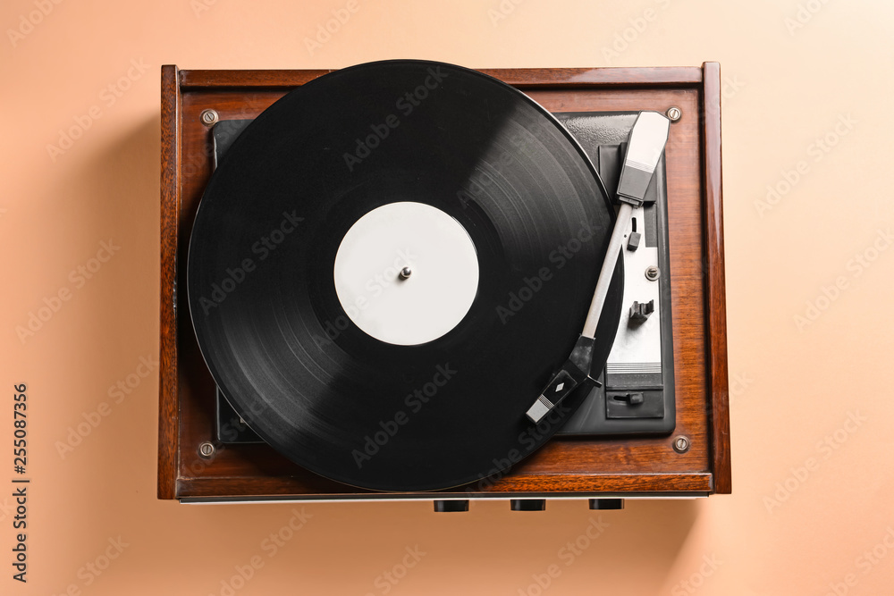 Obraz premium Record player with vinyl disc on color background