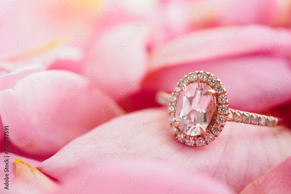 Jewelry pink diamond ring on beautiful rose petal background close up