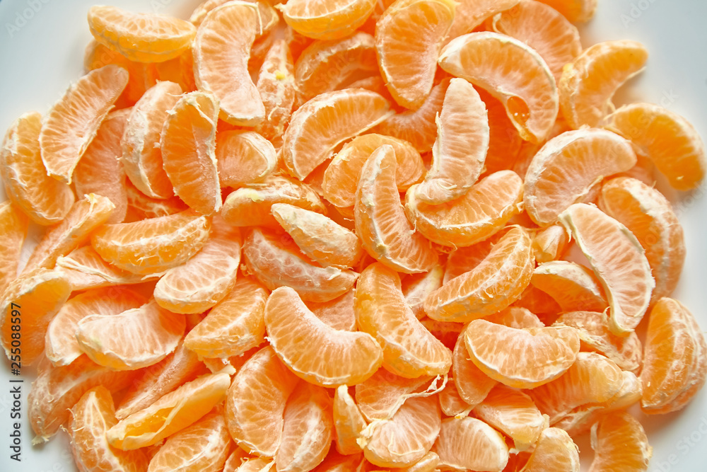 Segments of peeled tangerine. Mandarin fruit background Segments of peeled tangerine. Mandarin fruit background