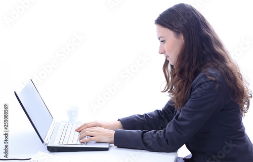 successful business woman typing on a laptop