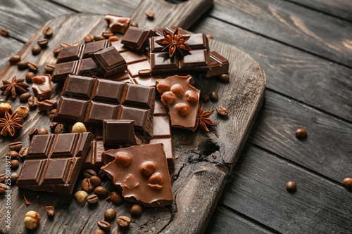 Sweet tasty chocolate on wooden board
