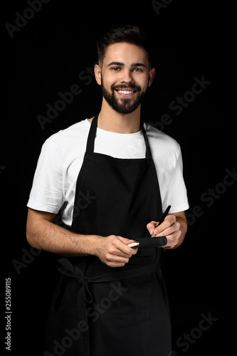 Handsome waiter with notebo...