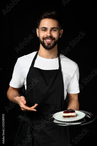 Handsome waiter with desser...