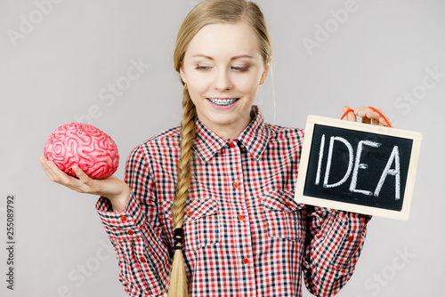 Woman holding idea sign and brain