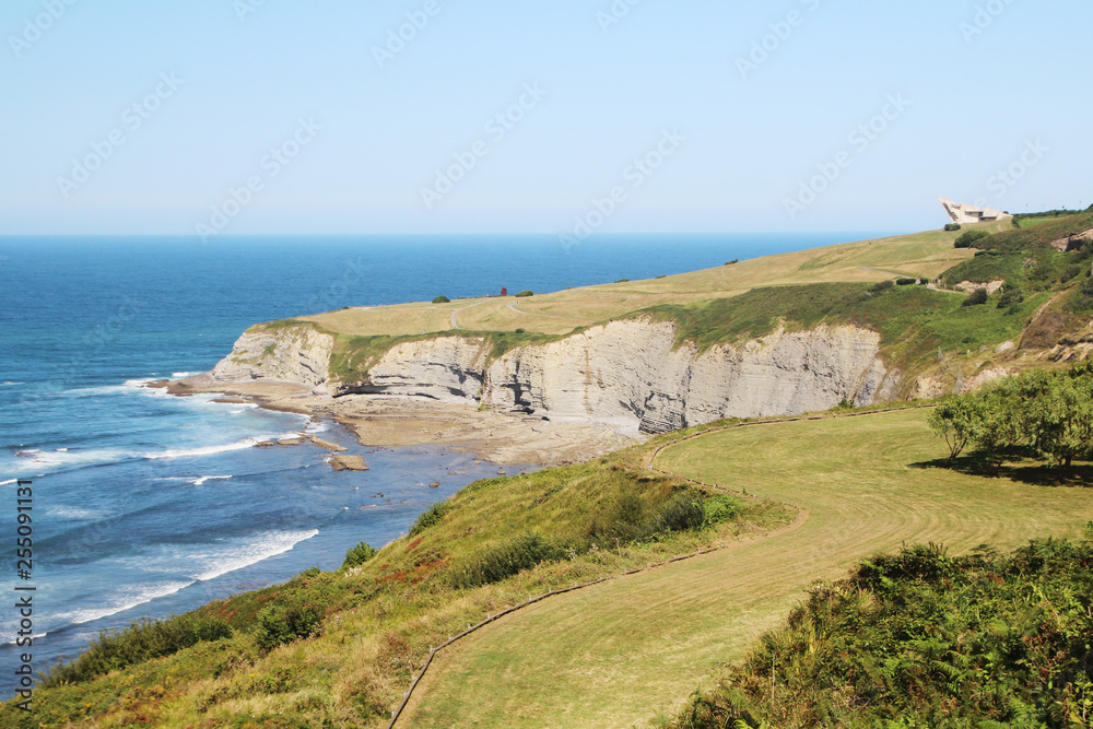 Coastline in Gijon, view to cliffs and ocean Coastline in Gijon, view to cliffs and ocean