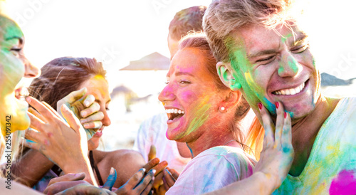 Happy friends having fun at beach party on holi colors festival event - Young people laughing together with candid excited mood at summer vacation - Youth friendship concept on vivid contrasted filter