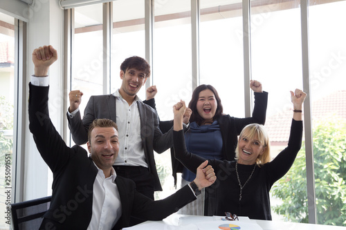 Obraz na plátně Successful startup entrepreneurs and business people team achieving goals celebrating giving high five in office