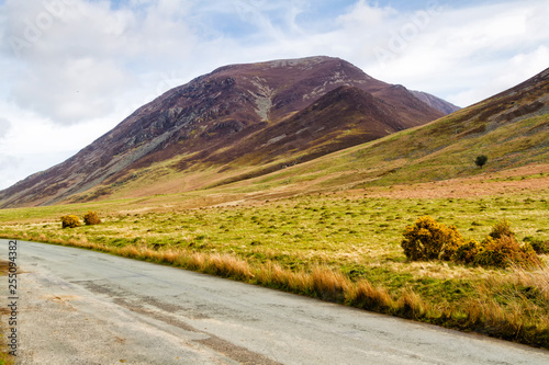 A lane running through moorland and livestock pastures in Lake District, Cumbria, England, UK photo