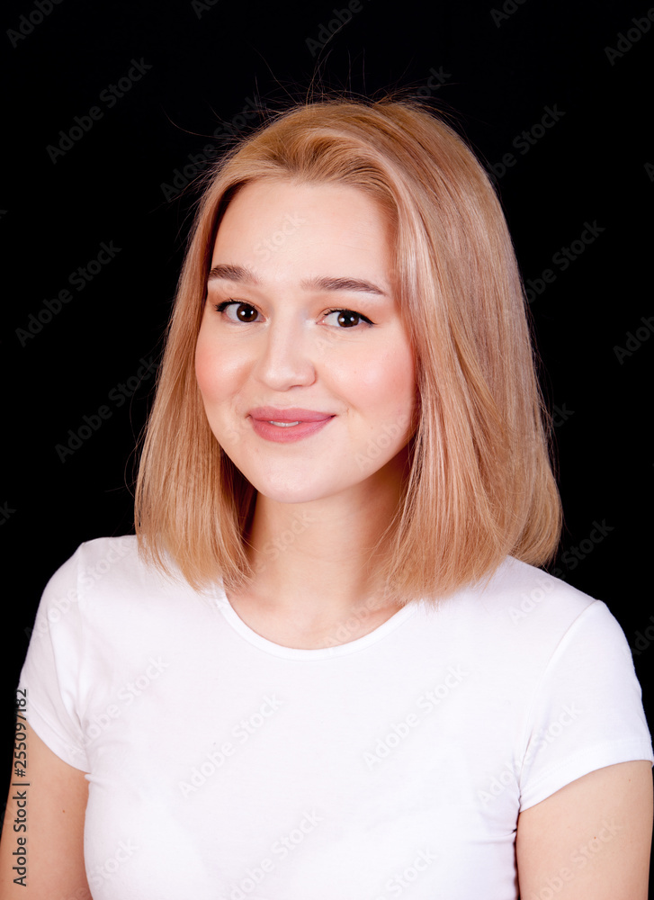 Young blonde woman smiling portrait on black background Young blonde woman smiling portrait on black background