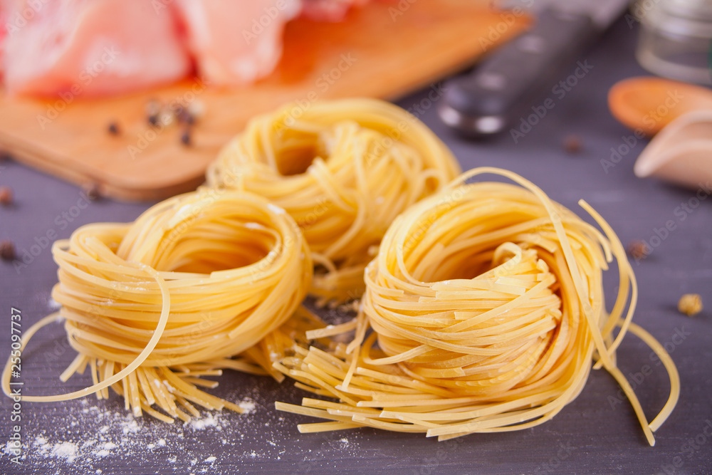 Italian egg pasta nest on black background Italian egg pasta nest on black background