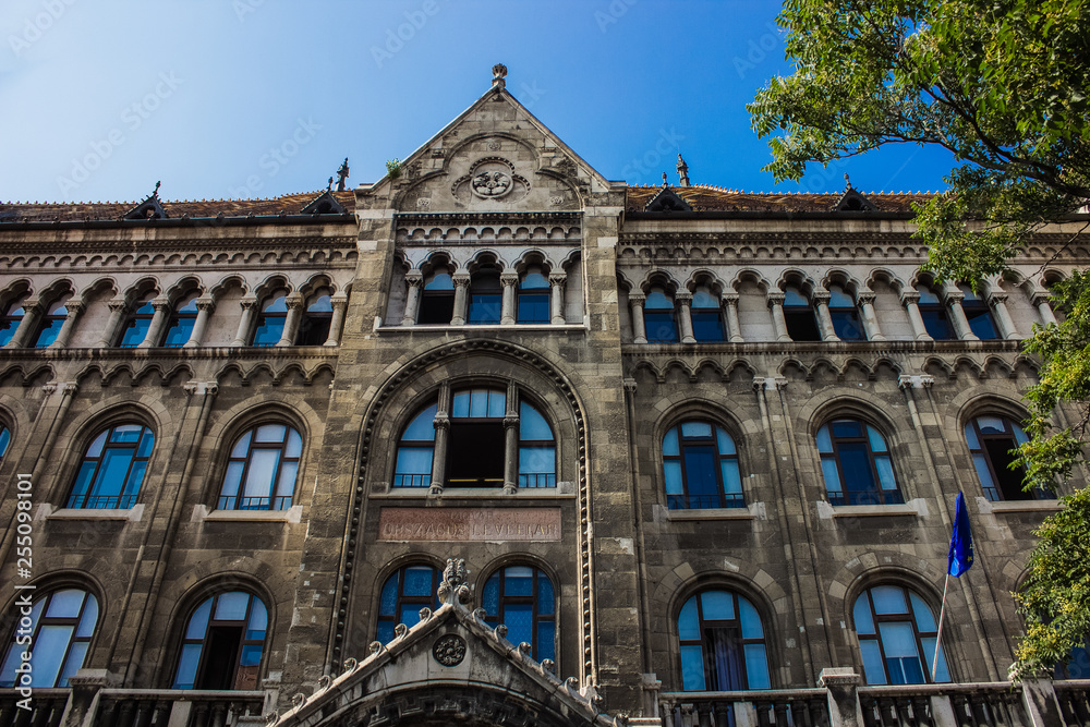 European old medieval building facade wall with bright blue arch windows glasses 