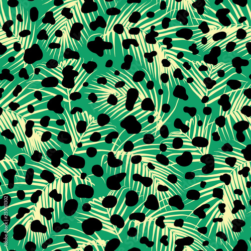 Seamless pattern with exotic palm leaves and black animalistic spots. Vector wallpaper. Tropical boho vibes and animal skin texture.