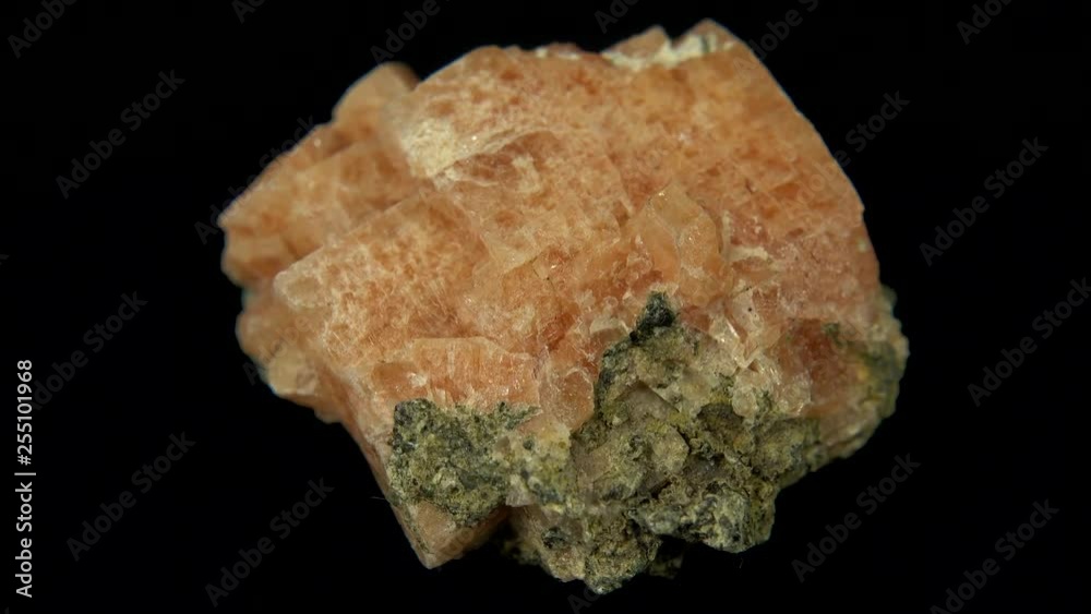 Seamlessly rotating a pink mineral (Chabazite-Ca) in front of black background Seamlessly rotating a pink mineral (Chabazite-Ca) in front of black background