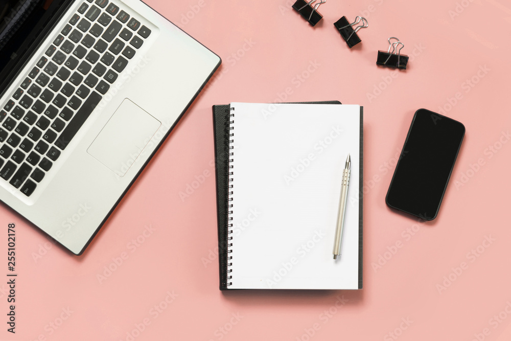 Workplace with open laptop, white and black accessory on pink. Top view and copy space. Workplace with open laptop, white and black accessory on pink. Top view and copy space.