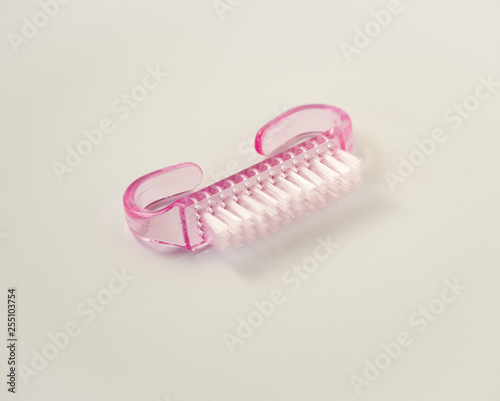 Pink cleaning nail brush on white background