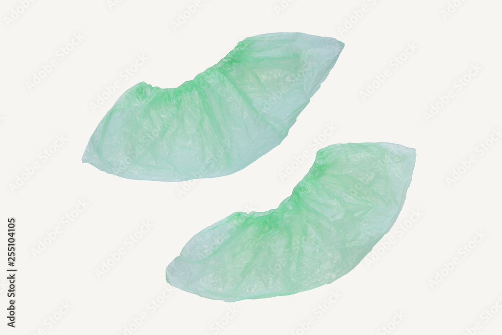 Fototapeta premium Two medical green shoe covers overshoes isolated on white background. Catalog top view